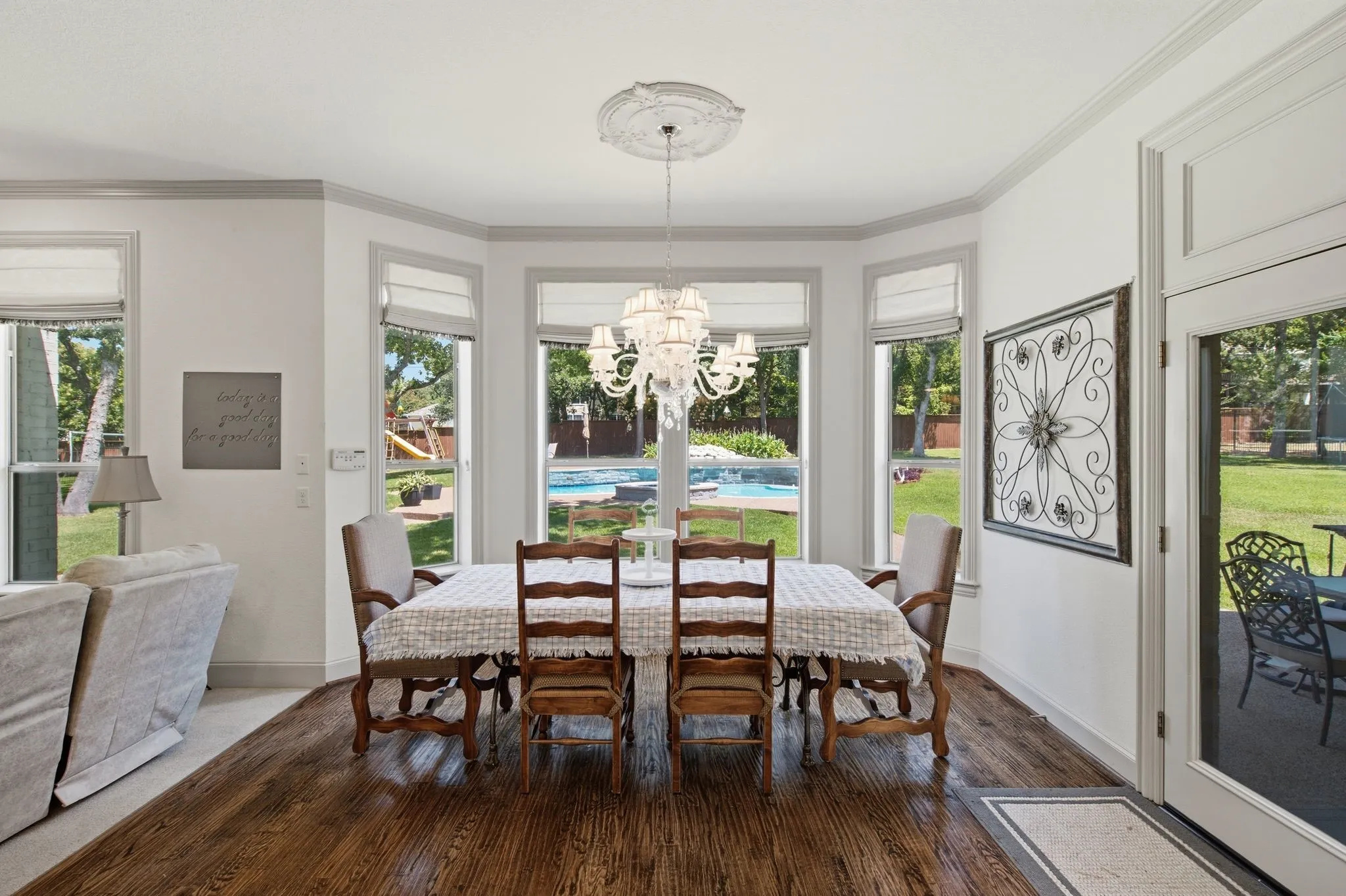 Dining area featuring a bay window, hardwood flooring, and a decorative chandelier