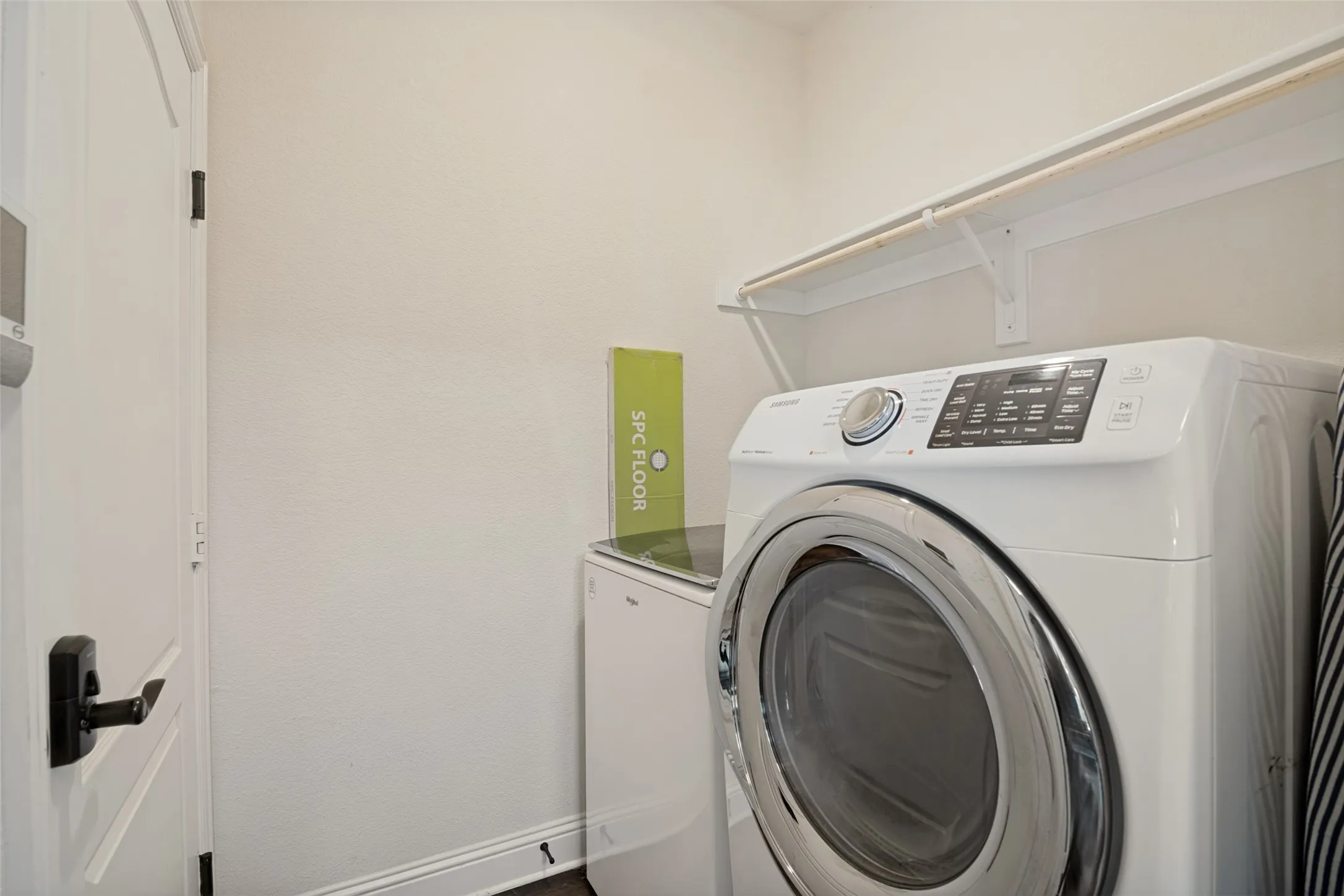 Dedicated laundry area featuring a front-loading washer and dryer