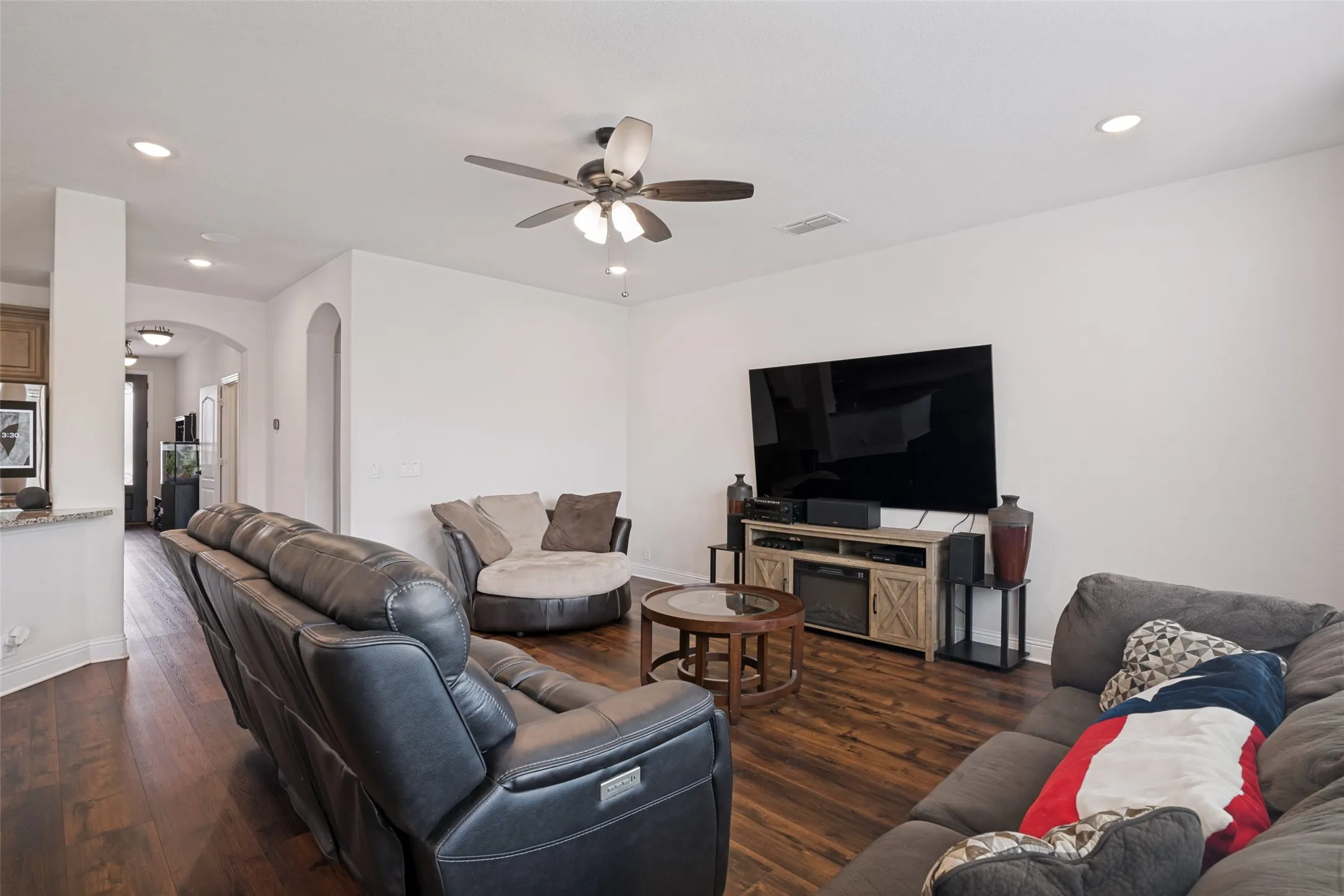 Spacious interior featuring wood-finish flooring, recessed lighting, and a ceiling fan