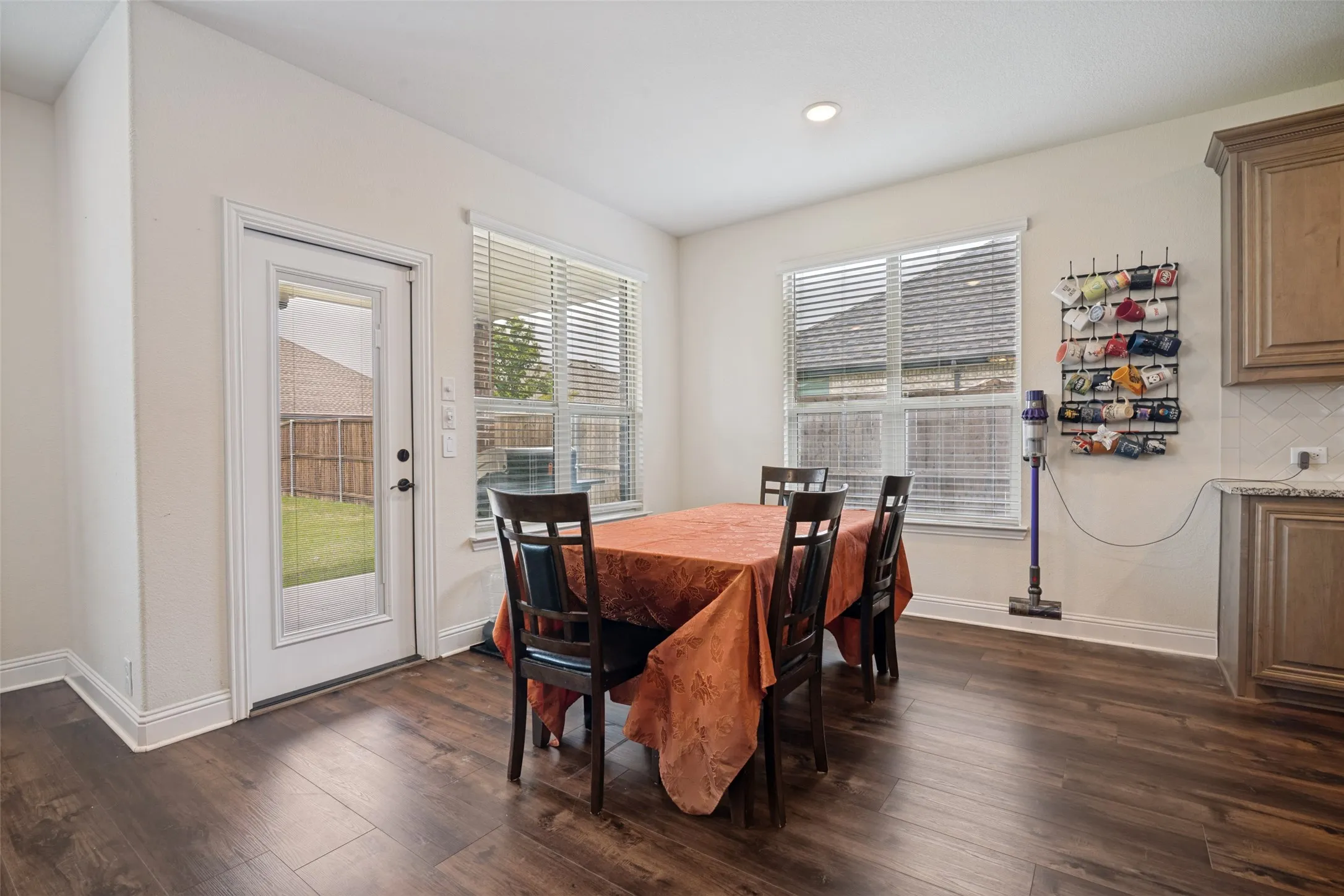 Dining area featuring wood-finish flooring, a white trim package, and recessed lighting