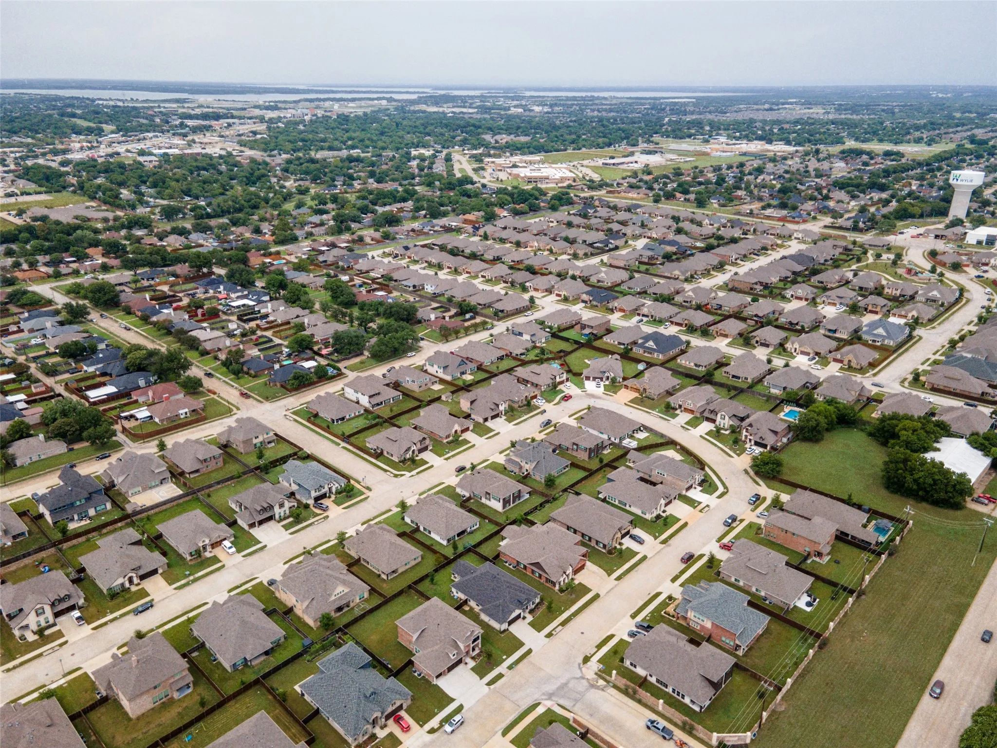 Expansive residential community featuring numerous single-family homes with varying rooflines and neutral exterior finishes