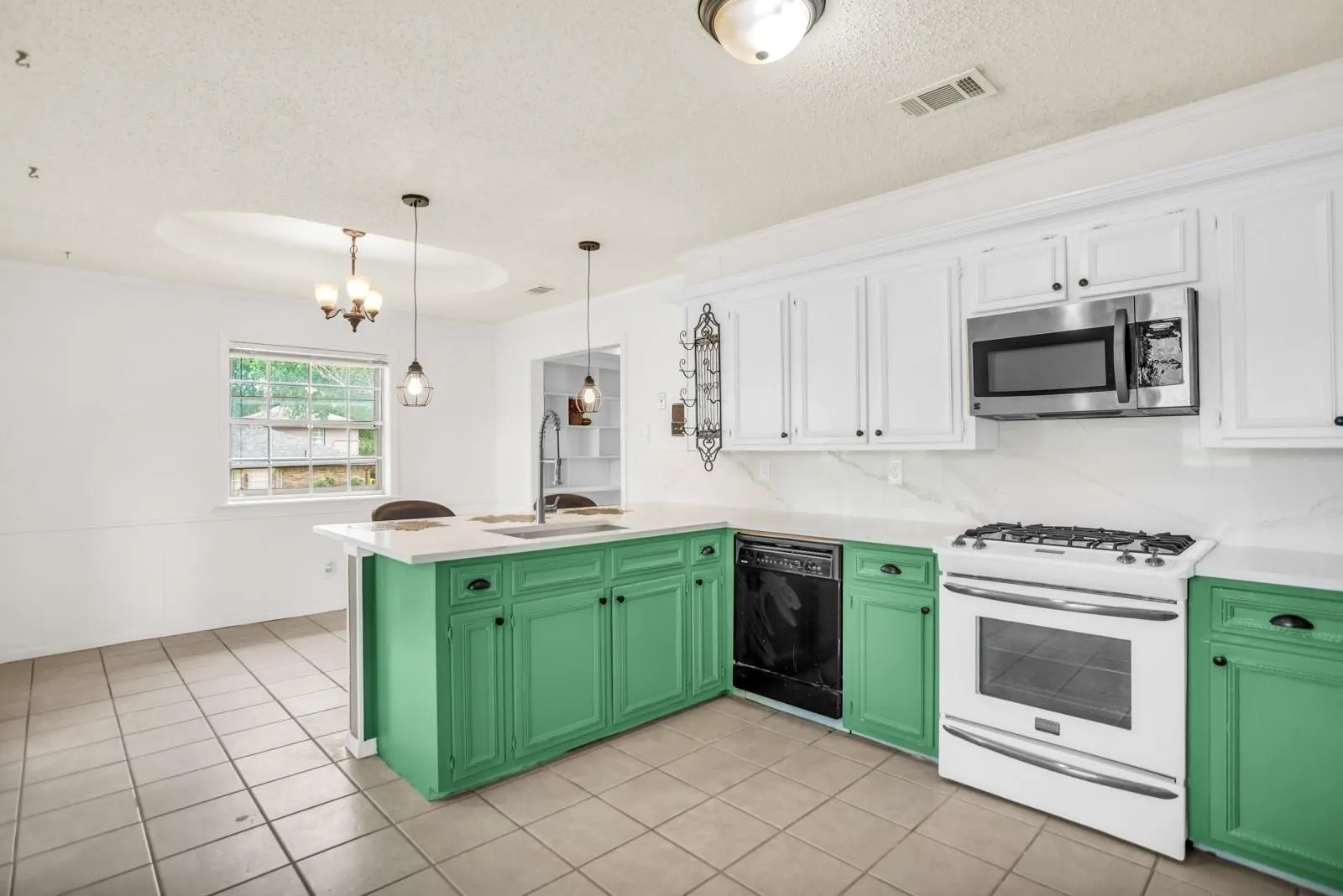 Kitchen featuring white upper cabinetry, vibrant green lower cabinetry, and white countertops