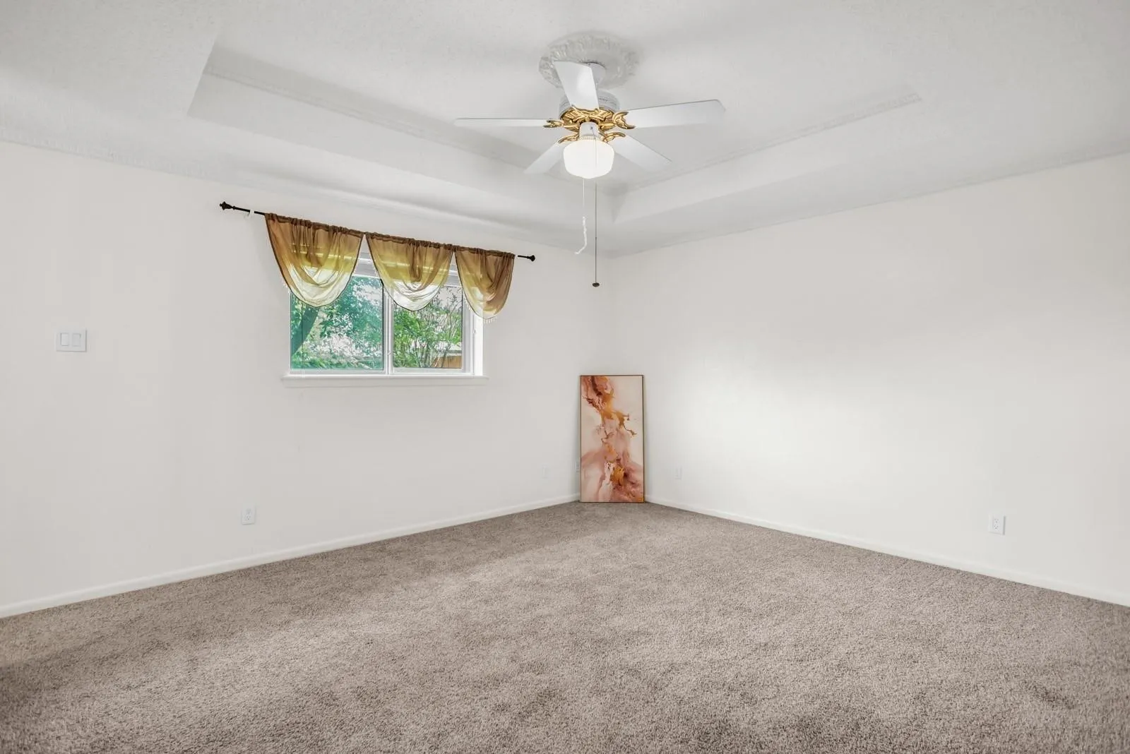 Recessed ceiling detail with a central ceiling fan