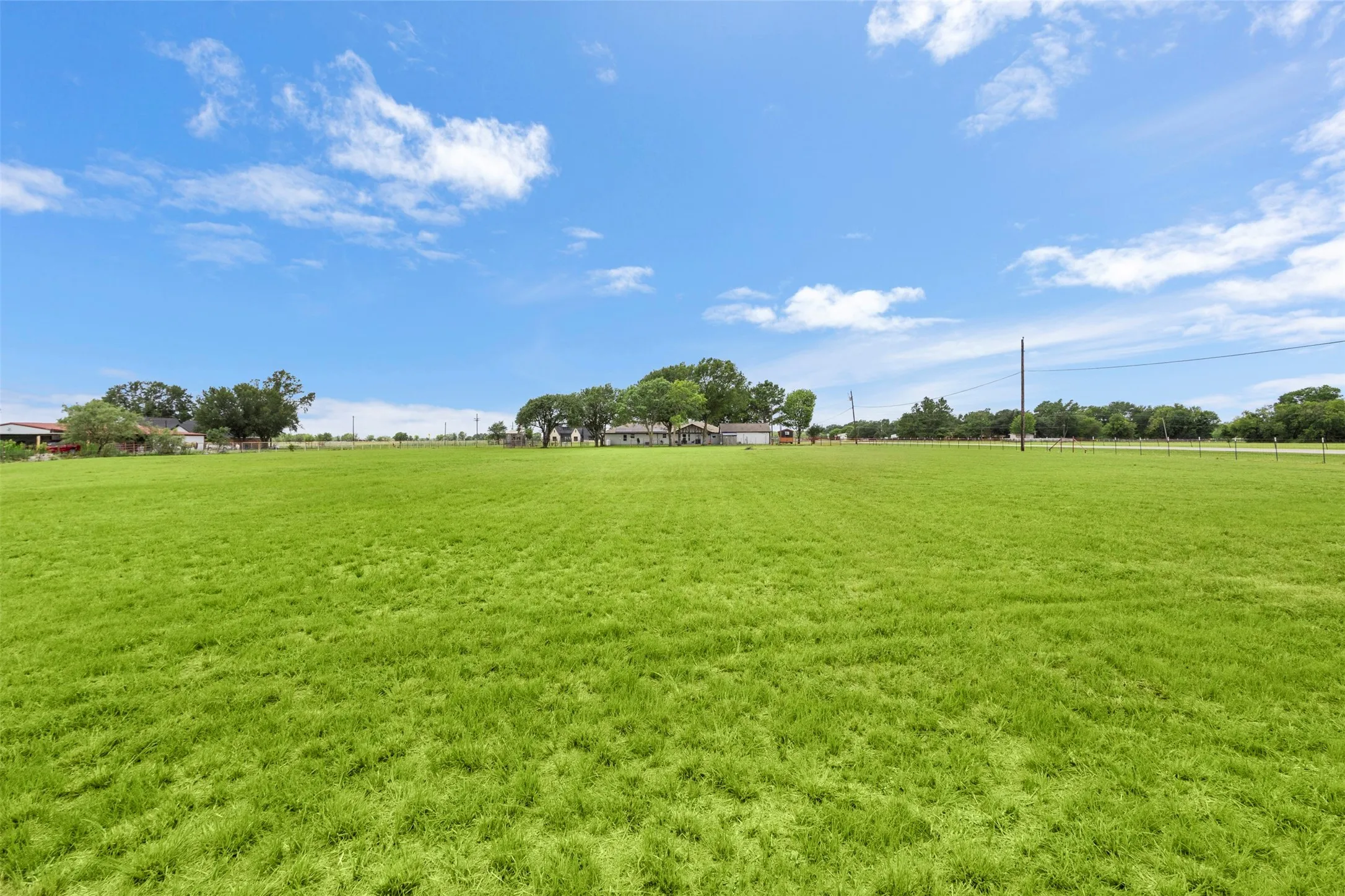 Expansive green acreage presenting a clear, open landscape