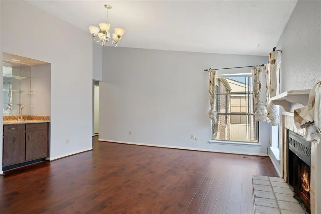 Open living area featuring rich wood-finish flooring