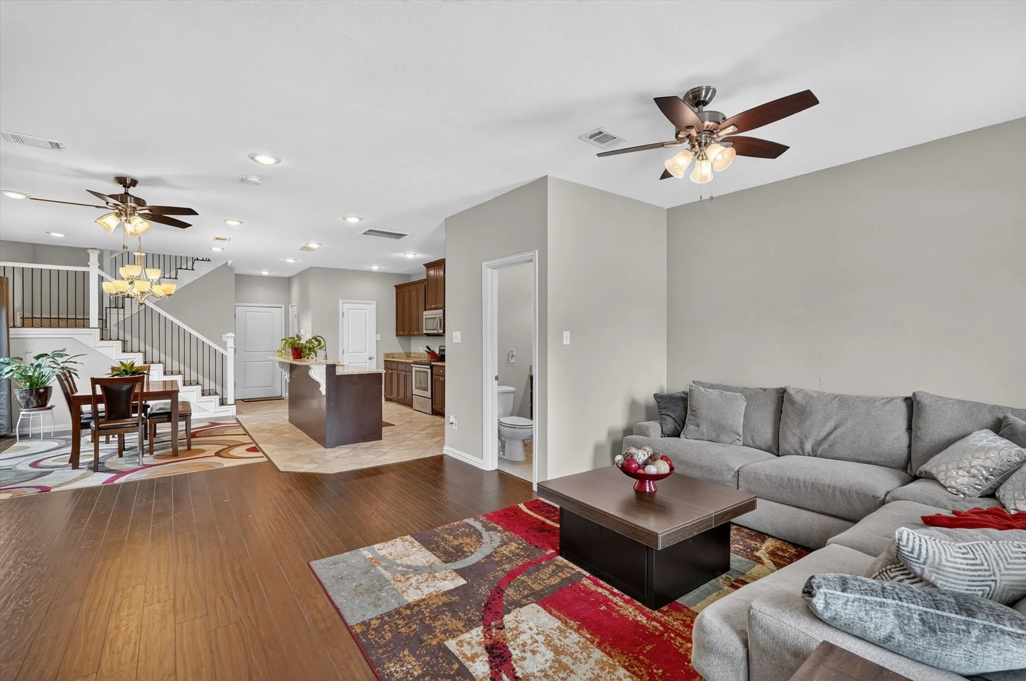 Open-concept living space featuring wood-finish flooring, recessed lighting, and a neutral wall palette