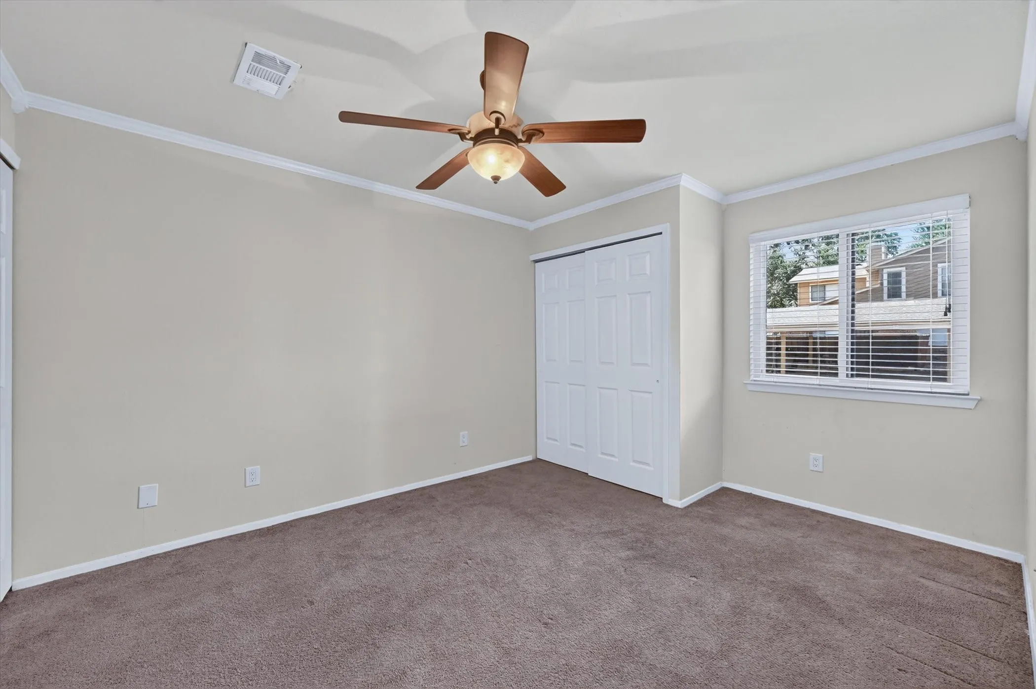 Neutral-toned wall paint throughout, complemented by crown molding and baseboards