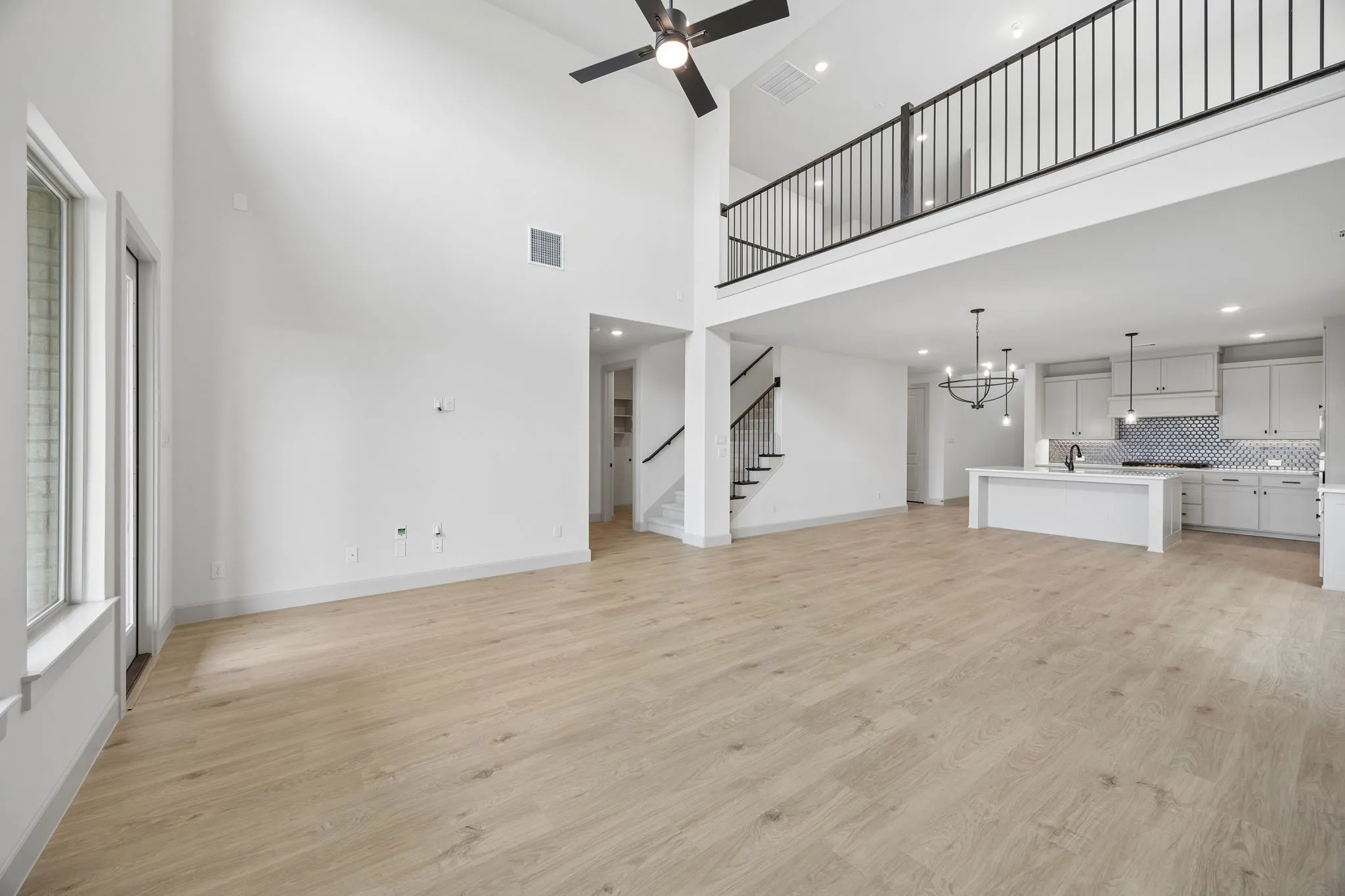 The family room is open to the game room upstairs creating multiple levels of open concept space for entertaining!