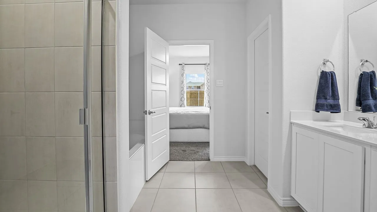 Bathroom featuring a tiled shower enclosure, a bathtub, a single vanity with a white countertop, and tiled flooring