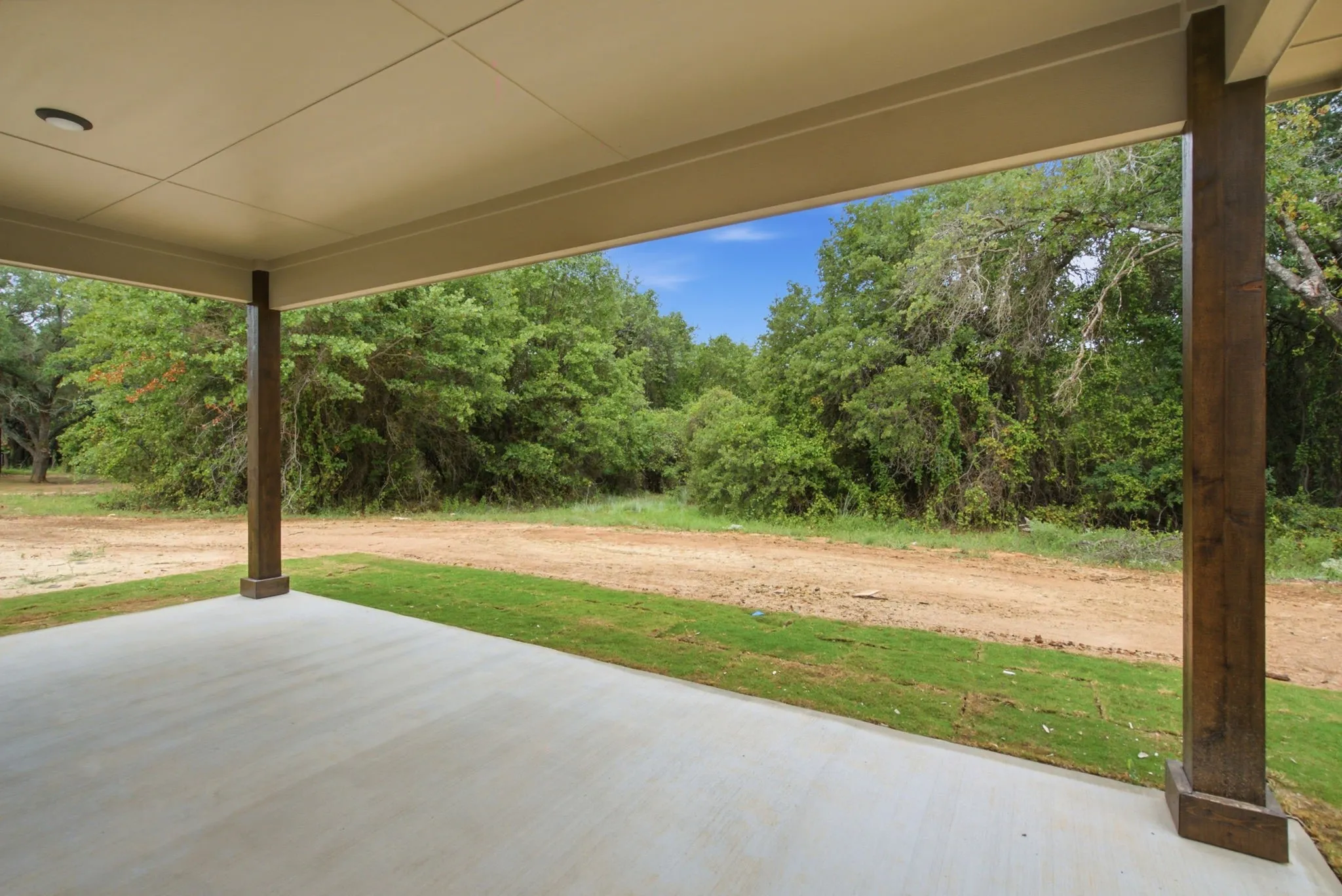 Spacious covered patio with concrete flooring