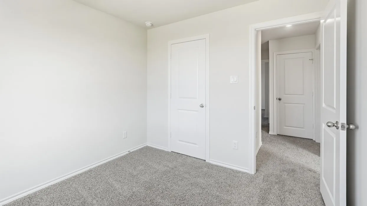 Interior room featuring light gray carpet flooring and white painted walls