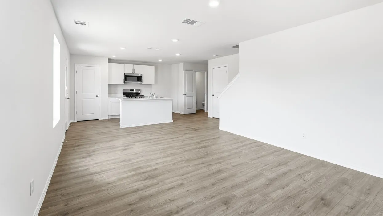 Open concept living area featuring wood-finish flooring and recessed lighting