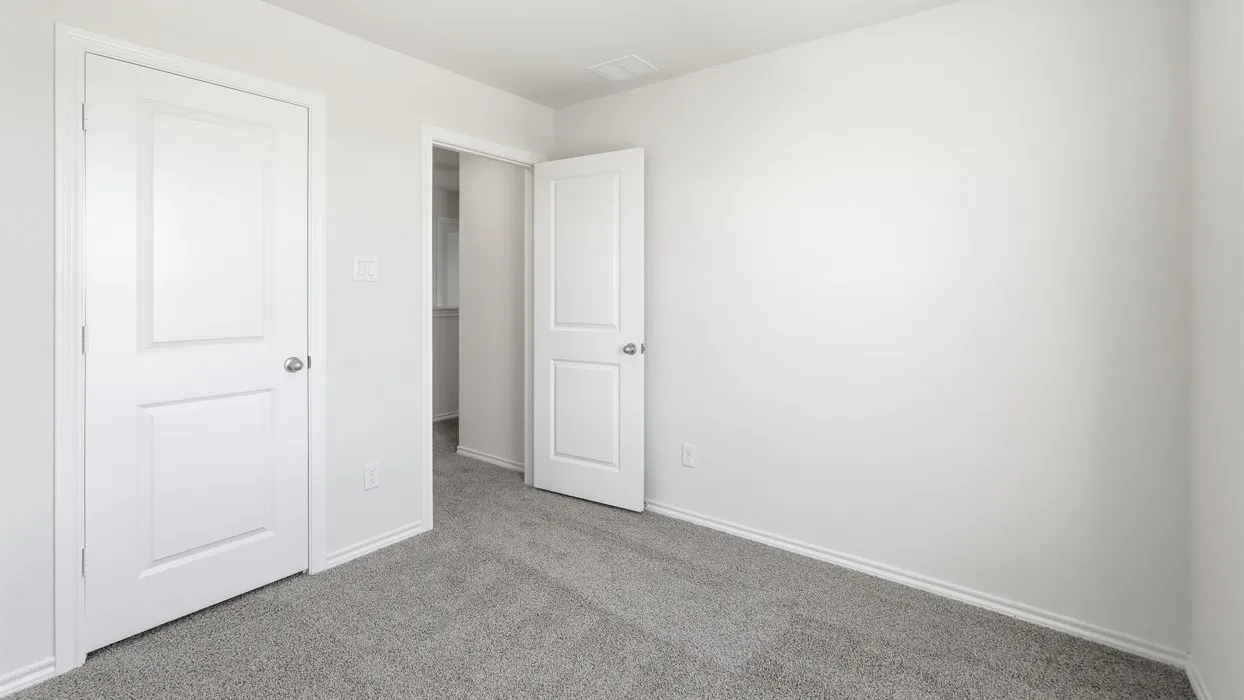 Interior room featuring light gray carpeting, white walls, and bright white trim