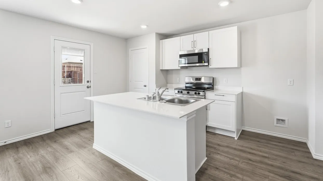 Kitchen featuring a center island with sink, white shaker cabinetry, stainless steel appliances, wood-finish flooring, and a glass-paneled door