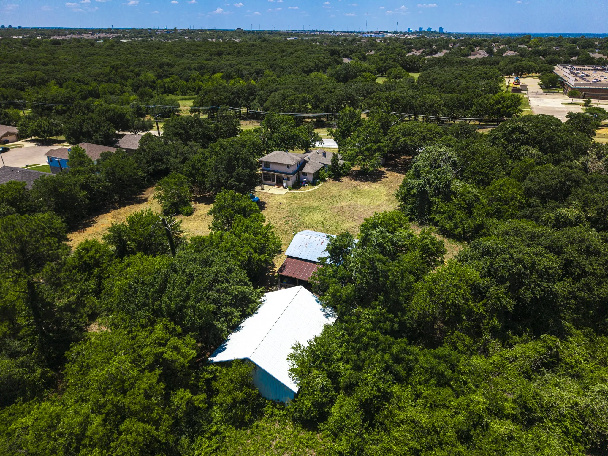 Spacious lot with extensive tree coverage and open grassy areas