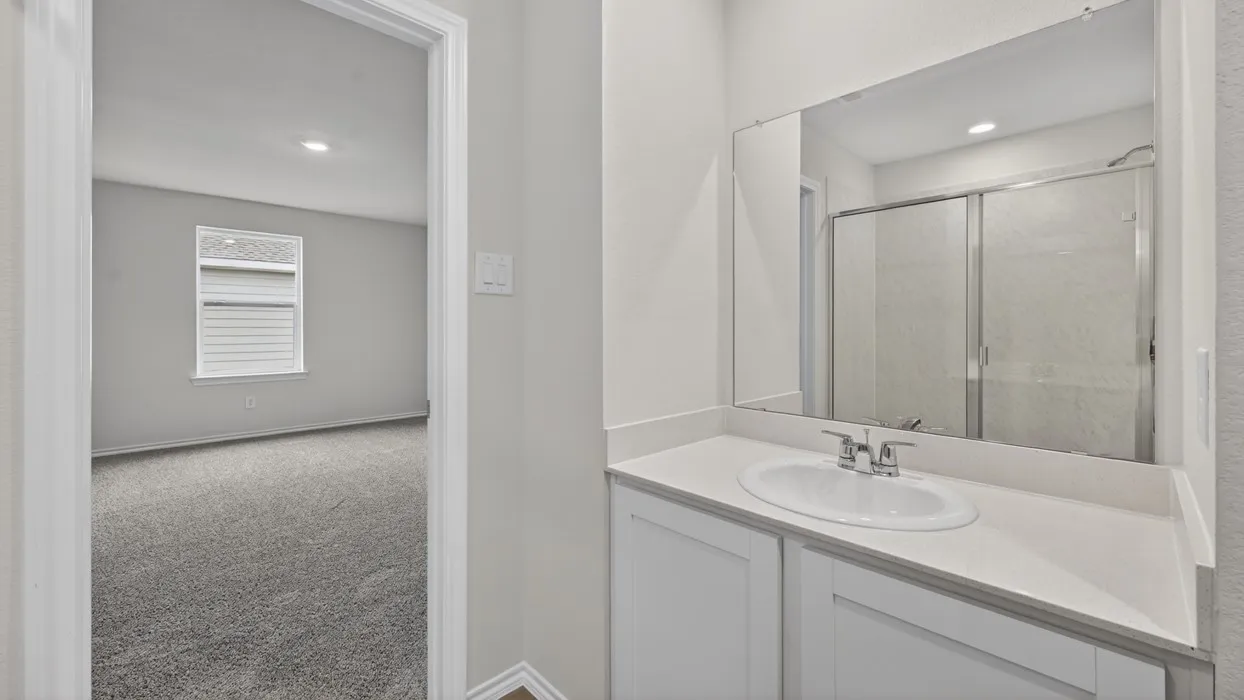 Contemporary bathroom vanity with an integrated sink, polished chrome faucet, and expansive wall-mounted mirror