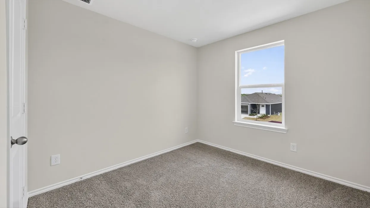 Neutral-toned room featuring a single window, light gray walls, gray carpet, and white trim