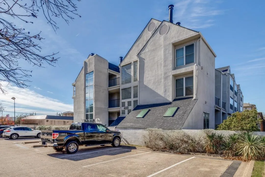 Multi-story building featuring a stucco exterior and a sloped roofline