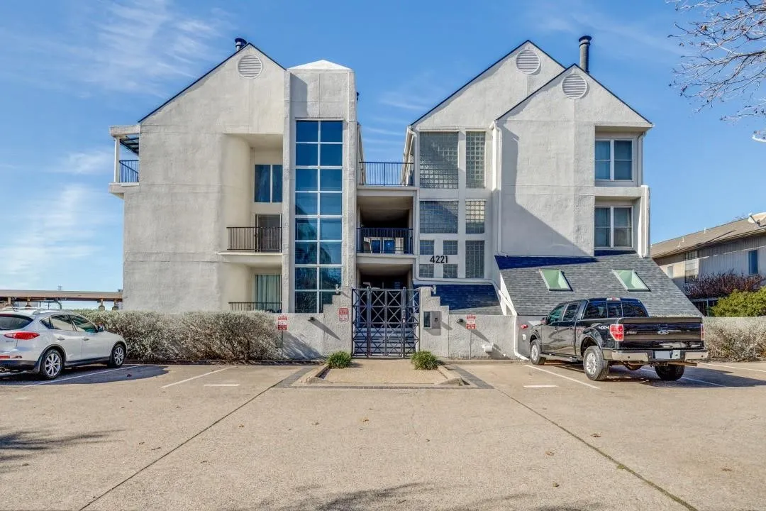Contemporary multi-story building featuring a stucco exterior and prominent architectural gables