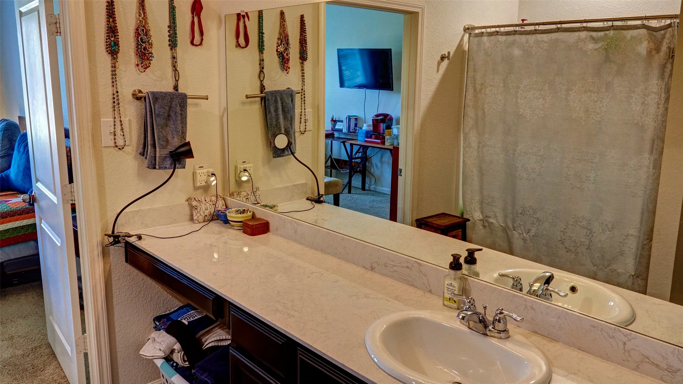 Extended vanity with an integrated sink and chrome faucet