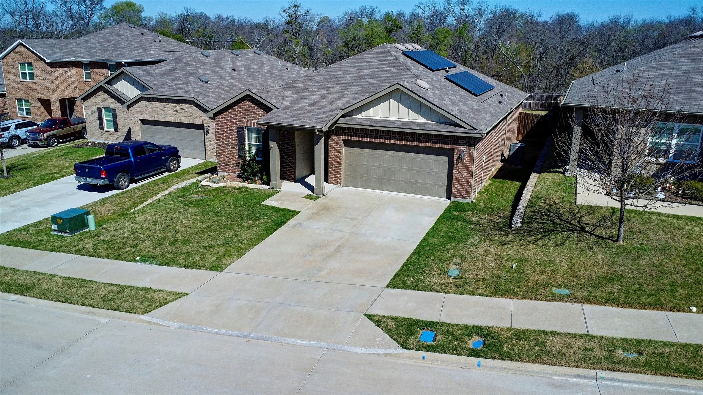 Brick exterior with a gabled roof and attached garage