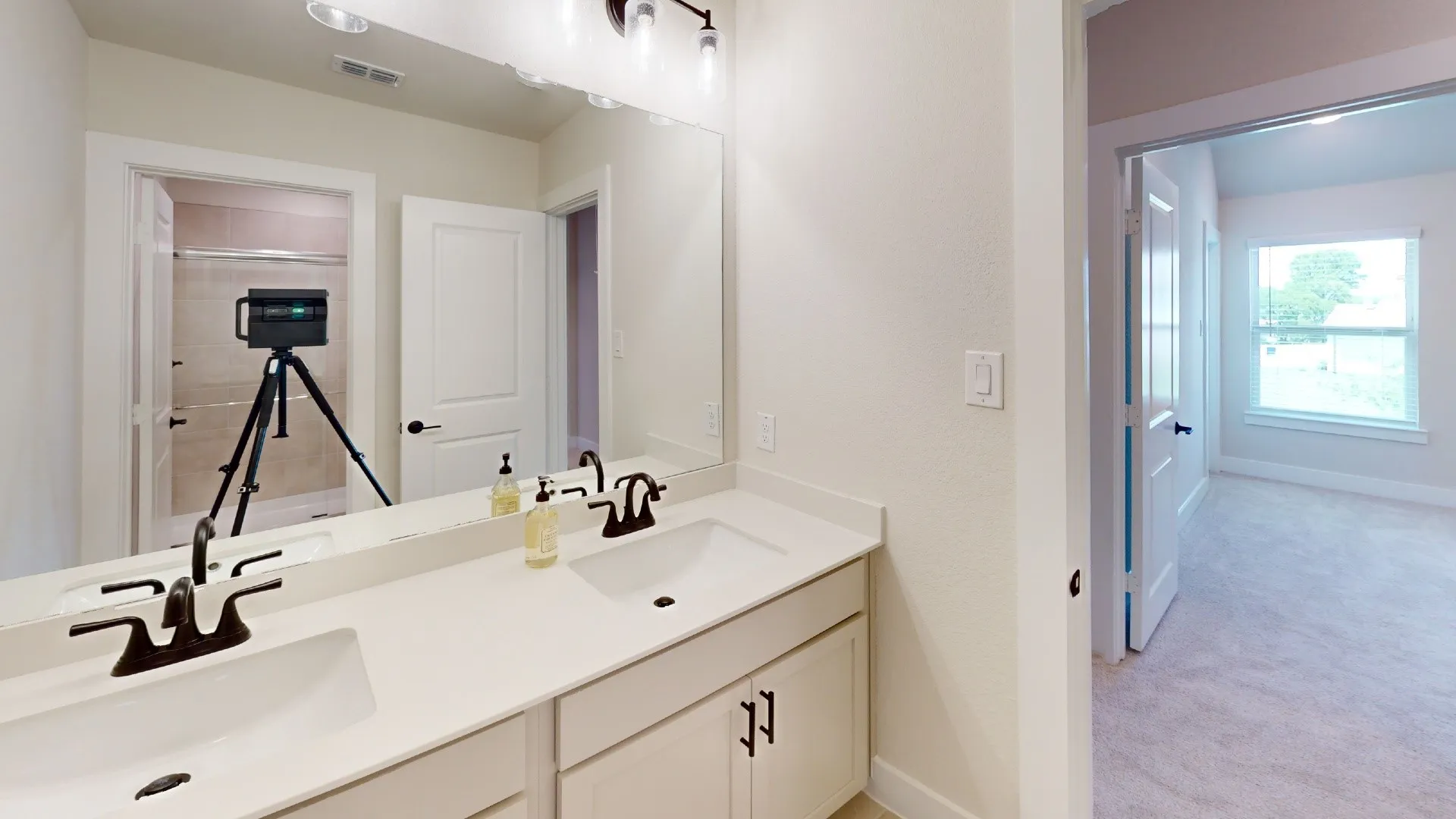 Dual sink vanity with white countertops, white cabinetry, and oil-rubbed bronze fixtures
