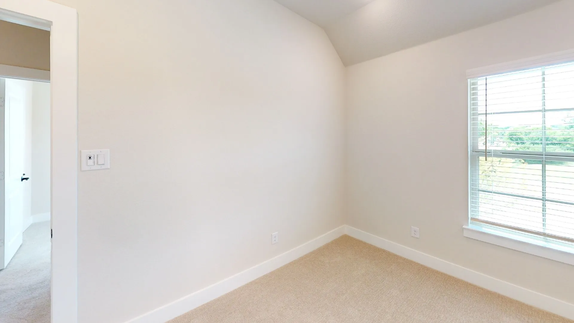Neutral tone walls with white trim and carpeting