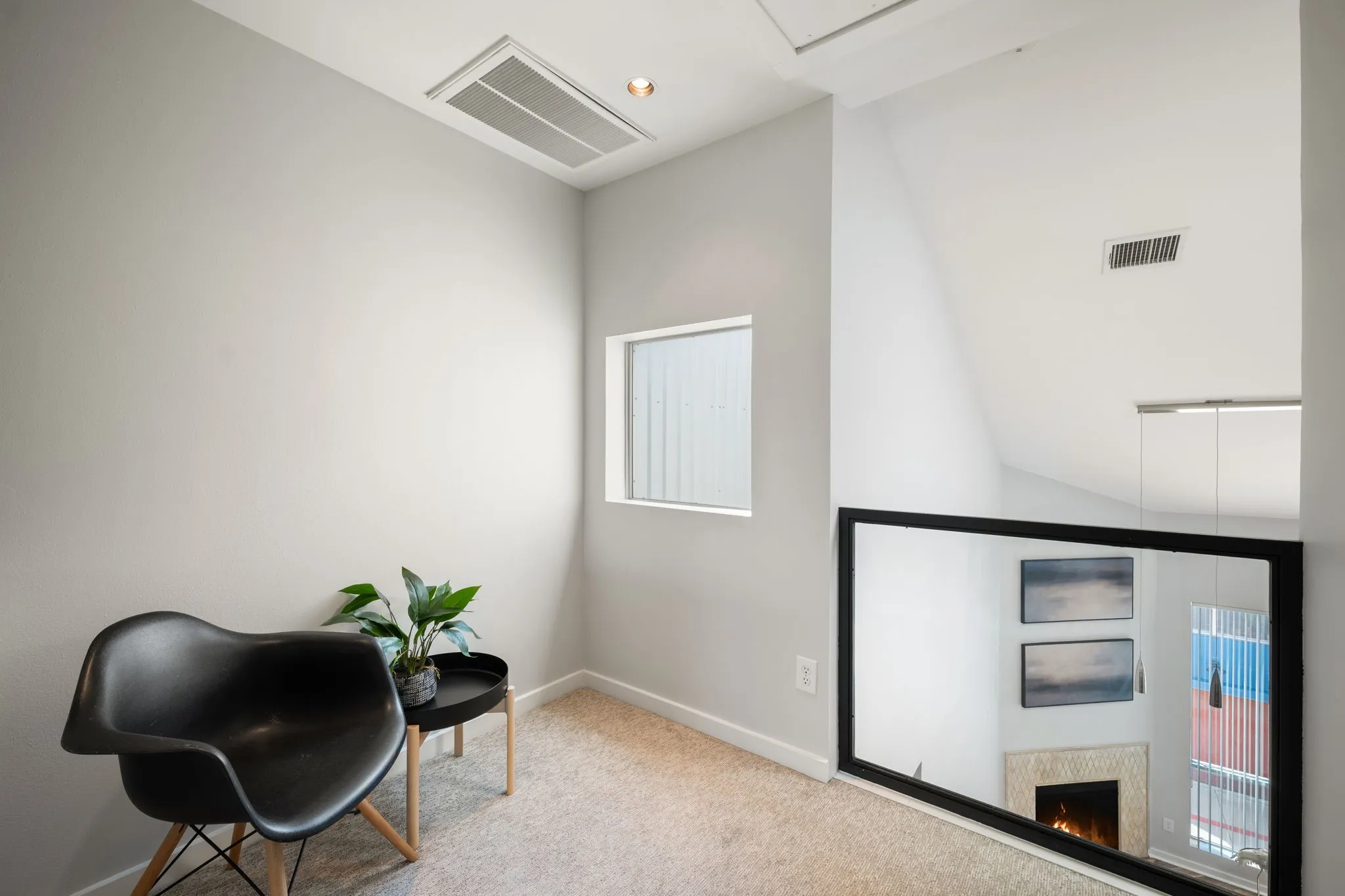 Upper level landing featuring light-colored carpeting and a rectangular frosted window