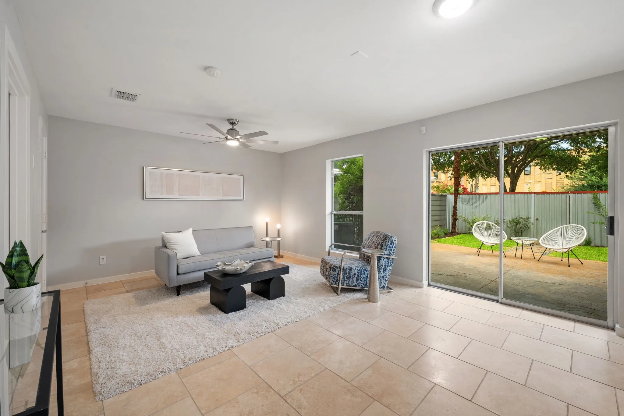 Living area featuring light-toned tile flooring, light gray walls, a ceiling fan, and recessed lighting