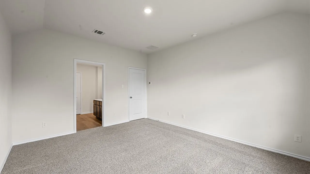 Spacious room featuring light gray carpeting, neutral wall finishes, a recessed ceiling light, and white trim