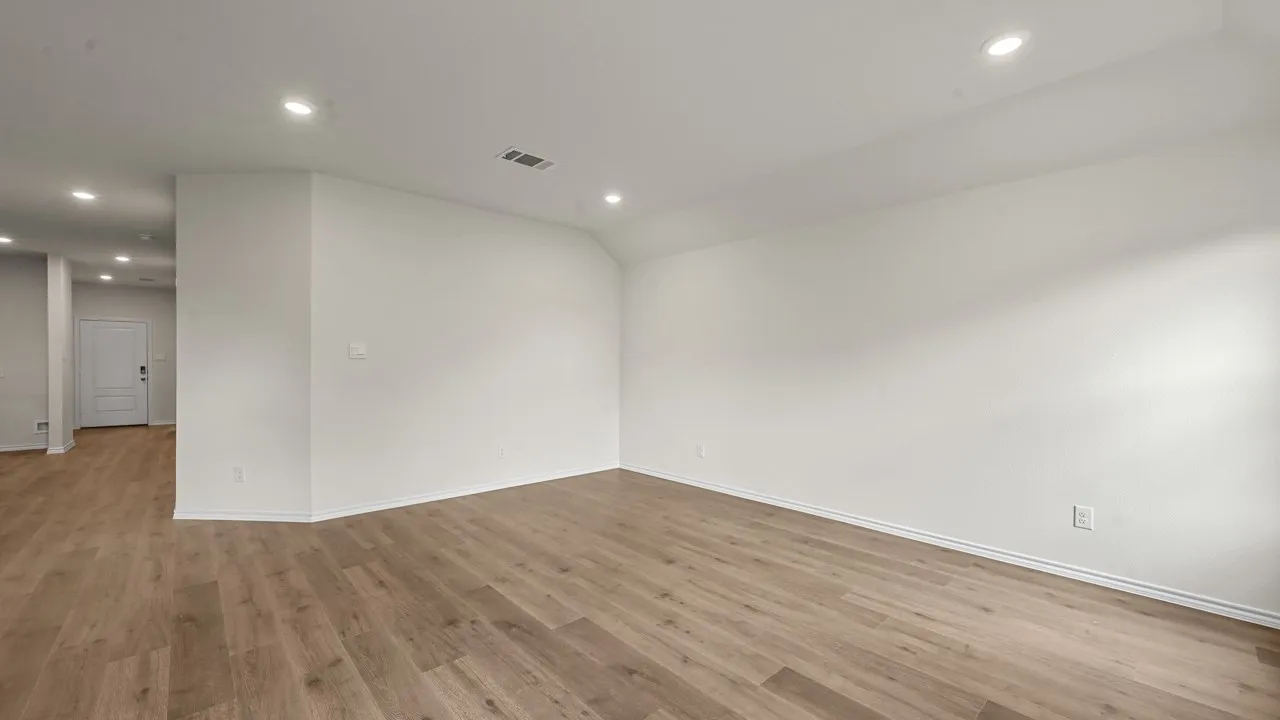 Open concept room featuring wood-finish flooring, recessed lighting, and crisp white walls