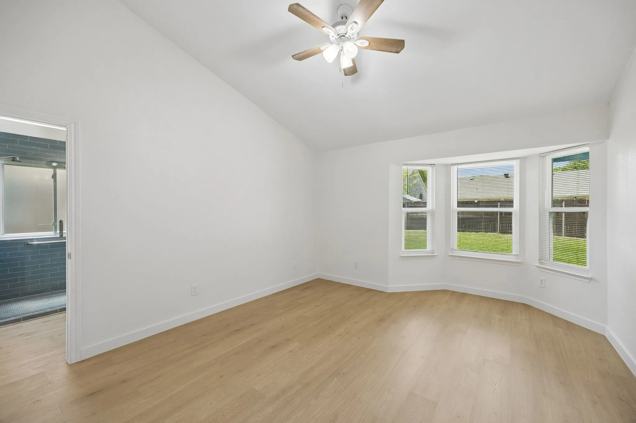 Retreat to the spacious primary suite, where vaulted ceilings, abundant natural light, and a charming bay window create a peaceful escape at the end of the day.