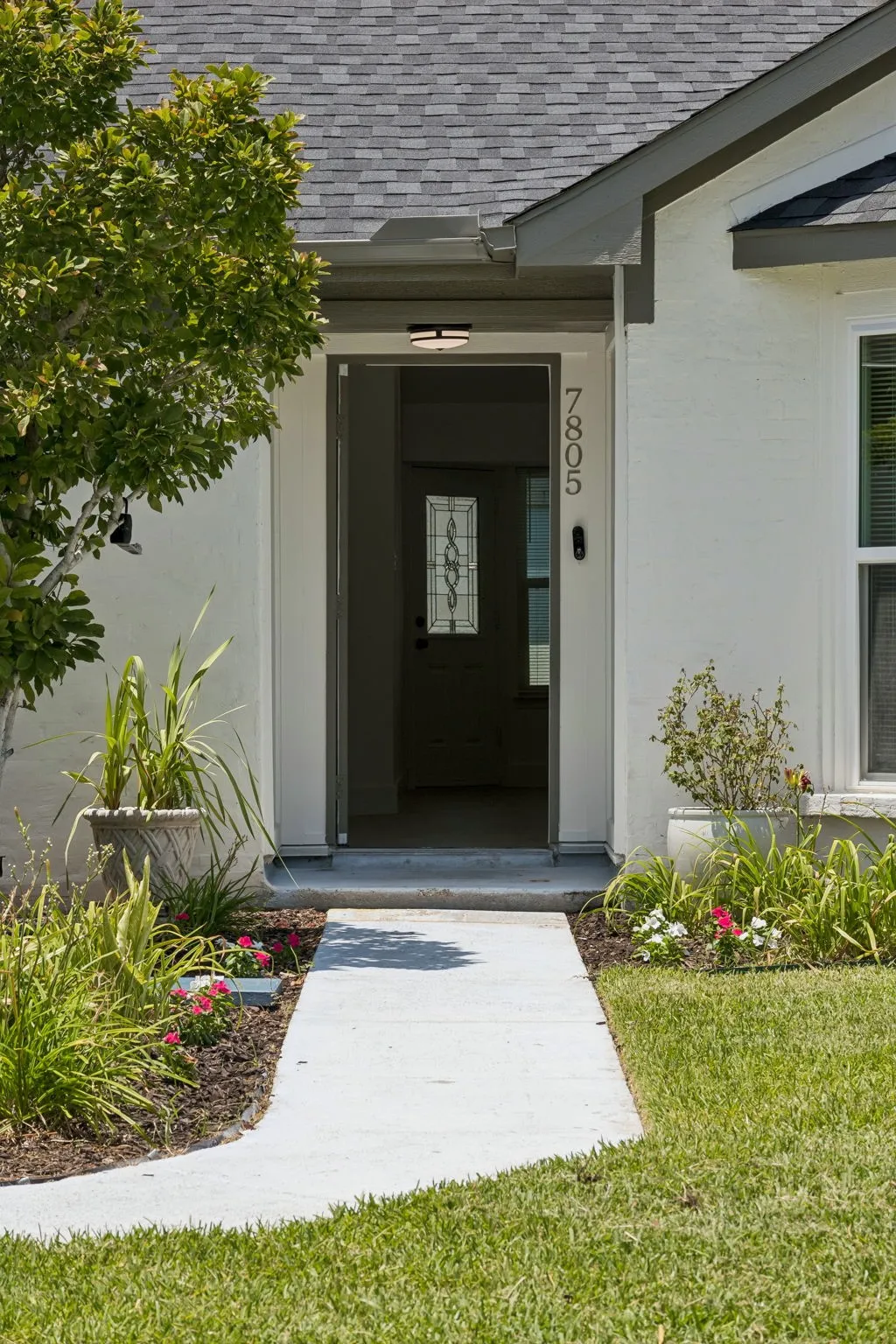 Thoughtful landscaping frame the inviting front entrance, creating a polished, move-in-ready appearance.