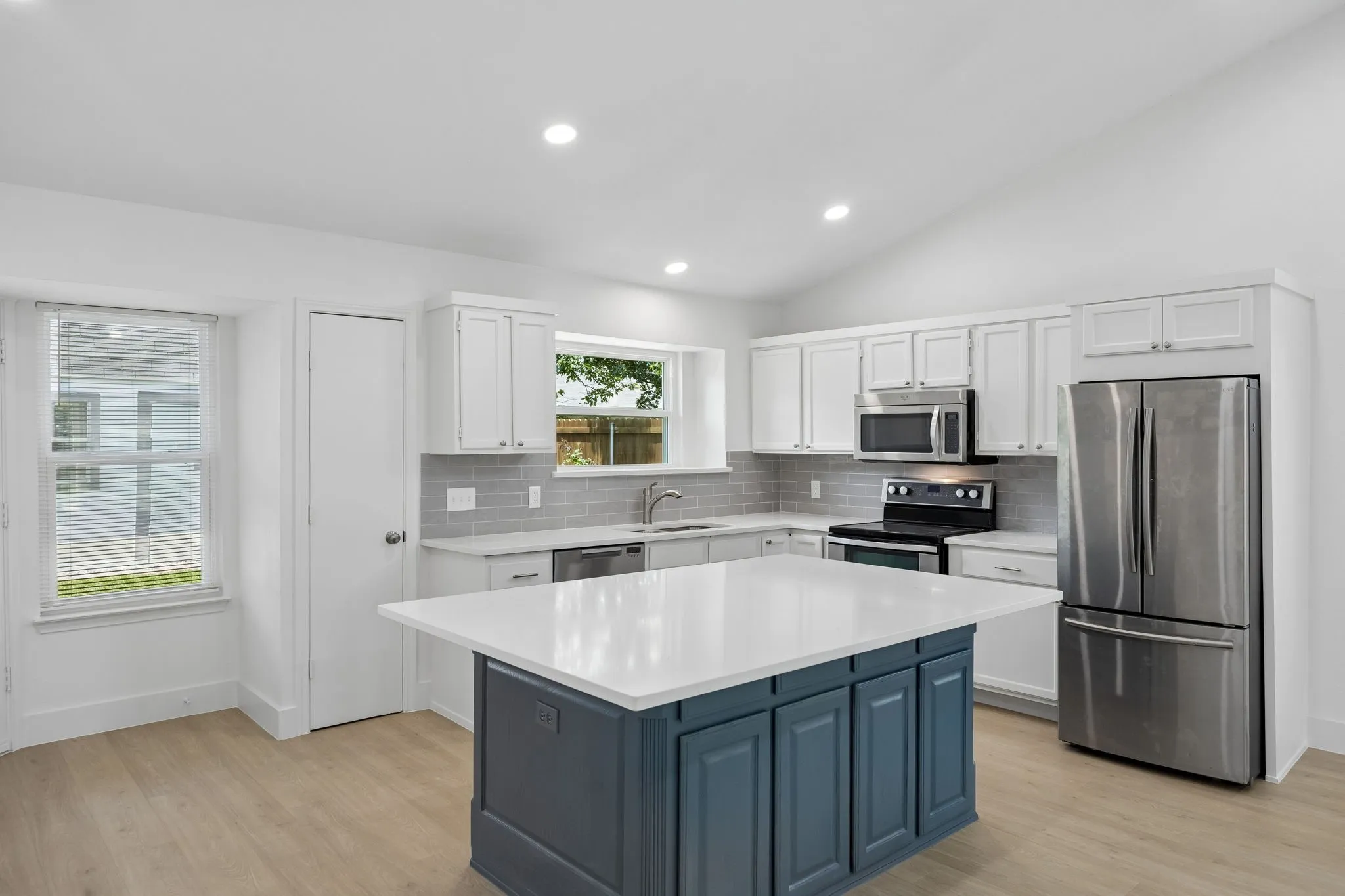 Designed with both style and functionality in mind, the kitchen offers abundant cabinet space, ample prep areas, and a spacious island perfect for casual dining and entertaining.