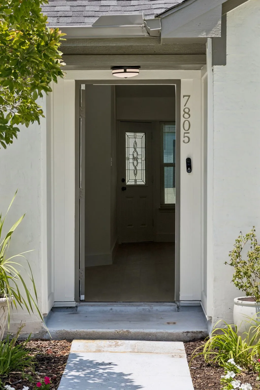 The sheltered entryway provides a warm welcome while adding architectural character and everyday convenience.