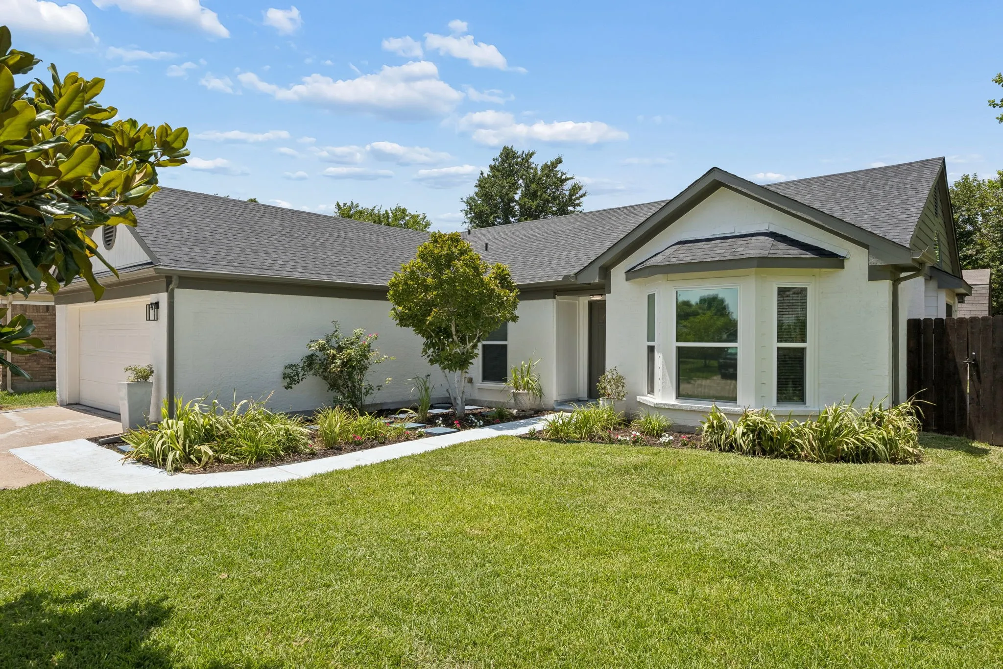 Modern updates blend seamlessly with established landscaping, creating a home that's both stylish and full of curb appeal.