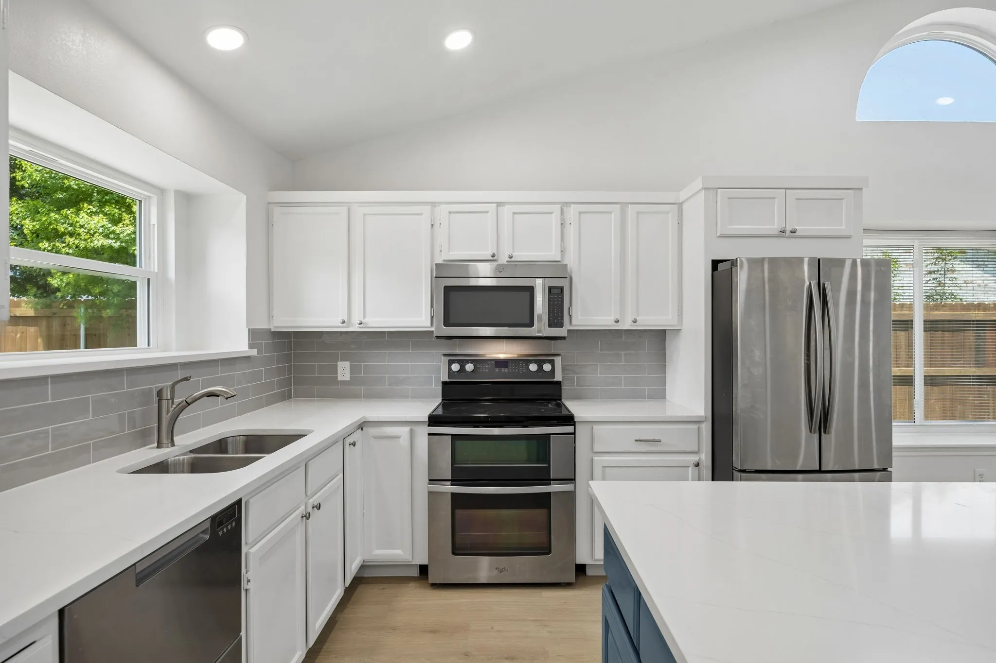 Featuring quartz countertops, subway tile backsplash, stainless steel appliances, and ample cabinetry, this thoughtfully renovated kitchen blends timeless style with everyday functionality.
