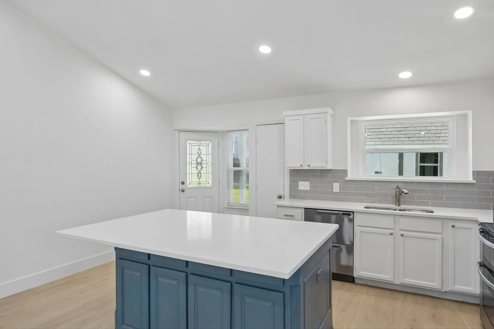 An oversized center island offers abundant prep space and casual seating. The kitchen boasts an effortless flow to the backyard, making everyday living as enjoyable as entertaining guests.