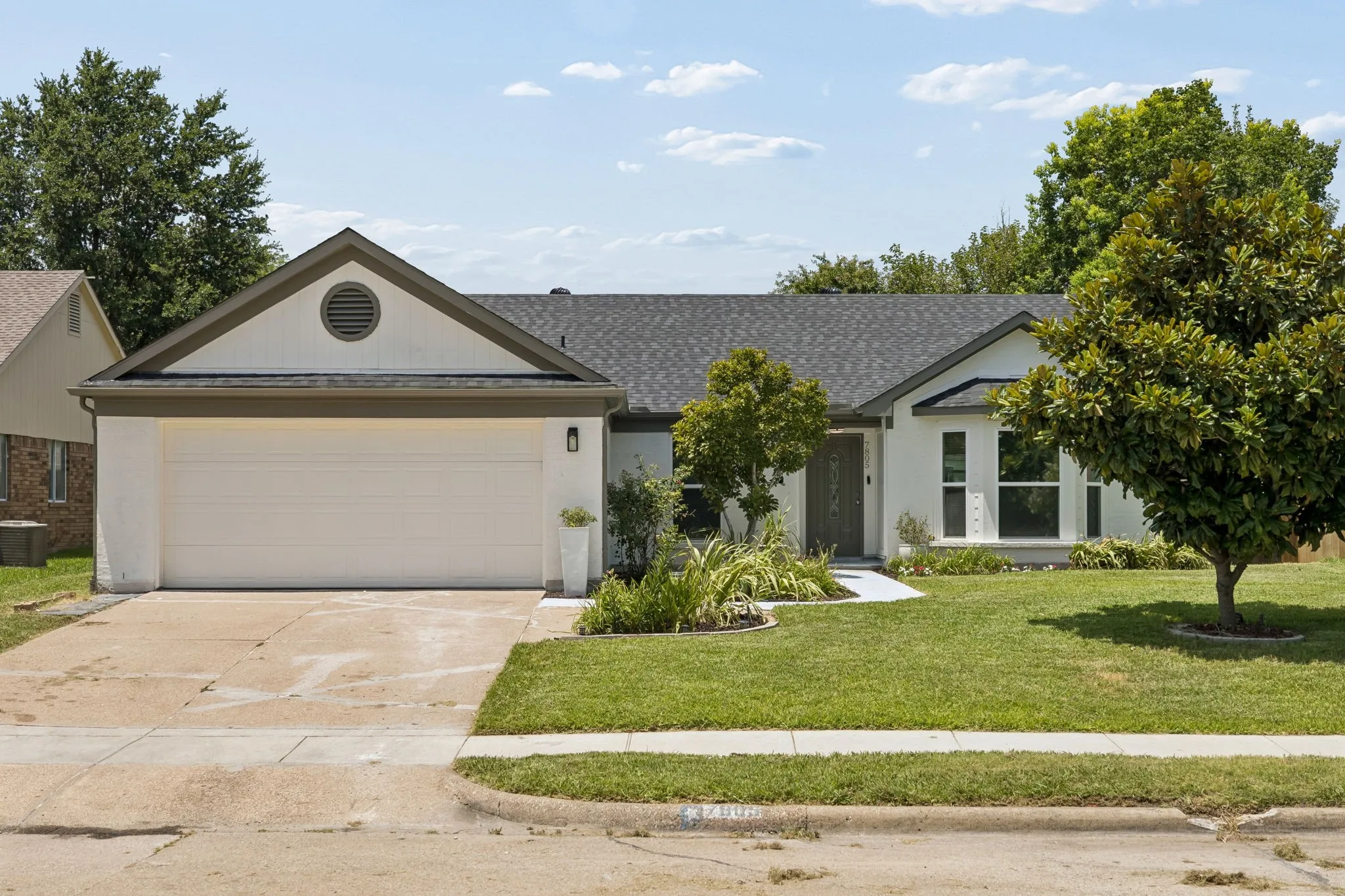 The beautifully refreshed exterior features a brand new roof, updated paint, and a welcoming walkway leading to the covered front entry.