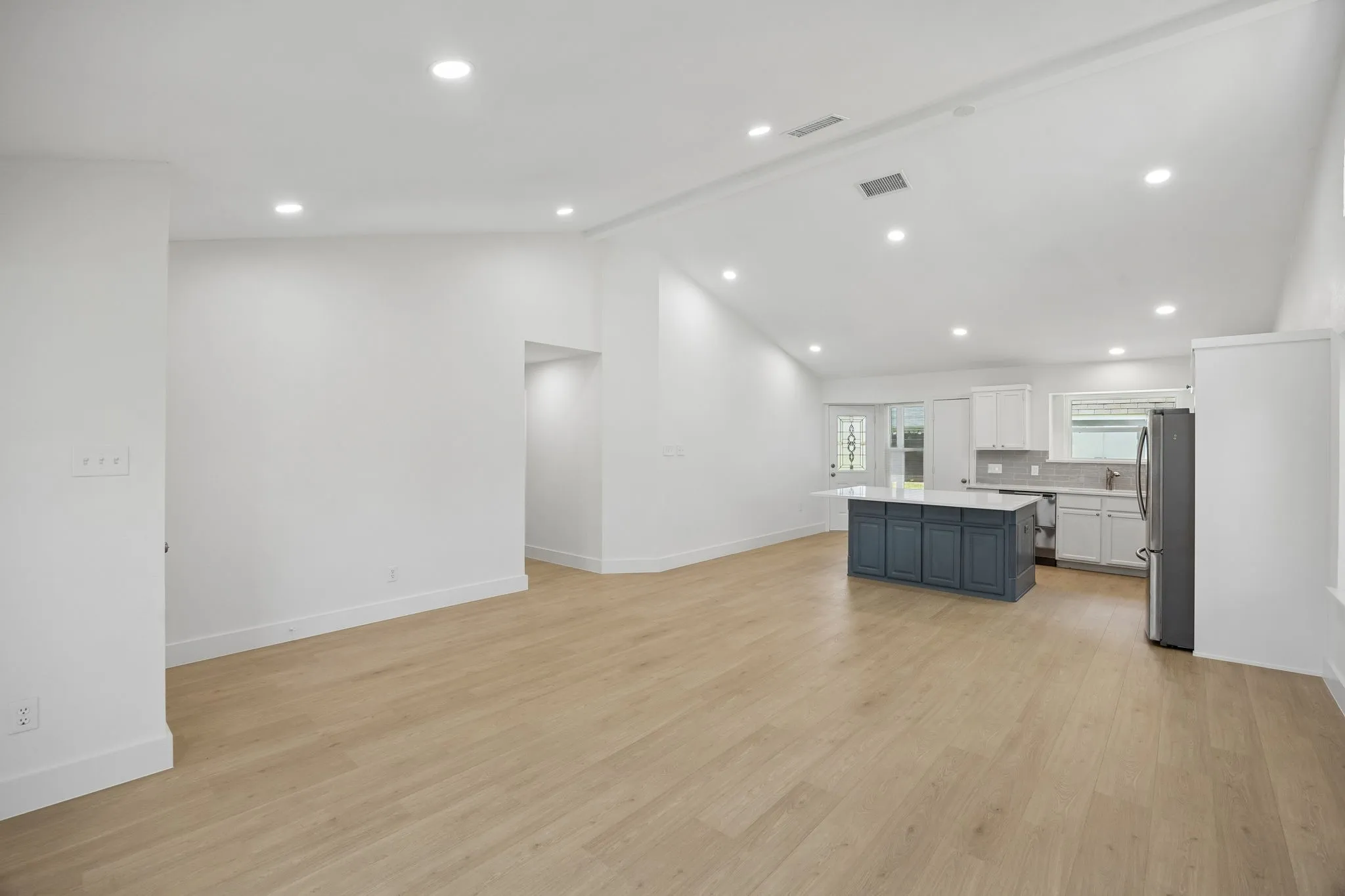 The seamless connection between the dining and living area and kitchen provides flexible space for gatherings both large and small.
