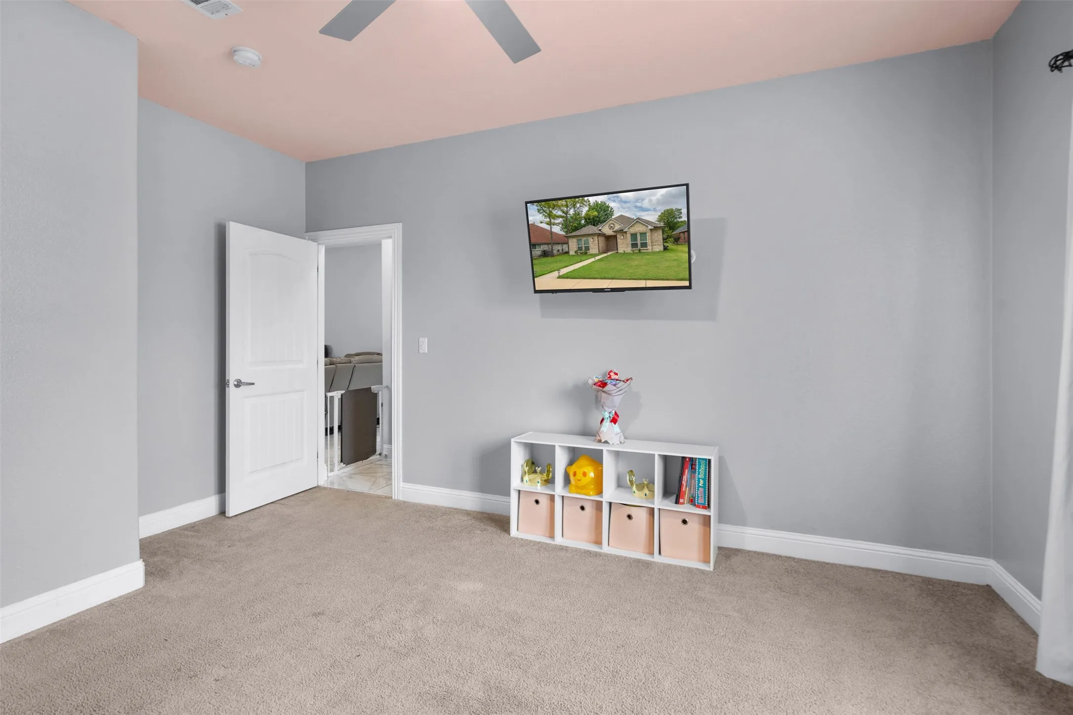 Game room with light colored carpet and baseboards