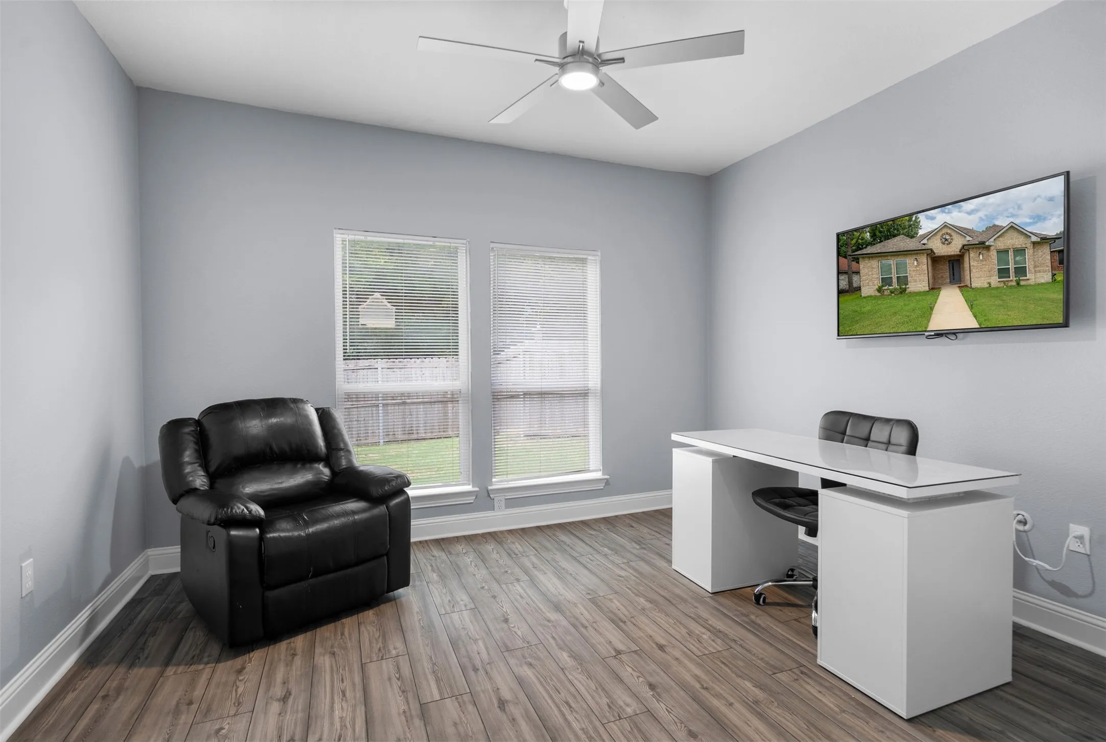 Office area with wood finished floors and ceiling fan
