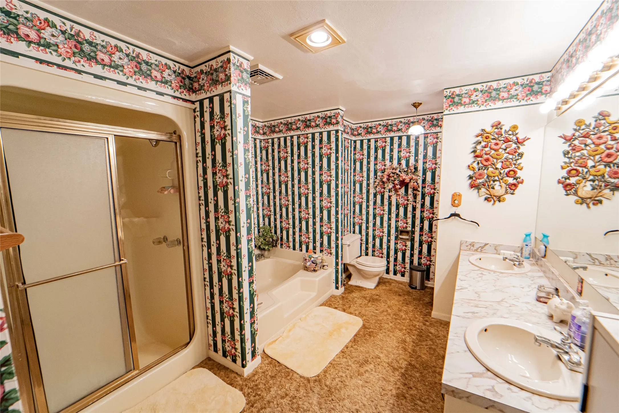 Bathroom featuring a dual vanity with integrated sinks and a large mirror