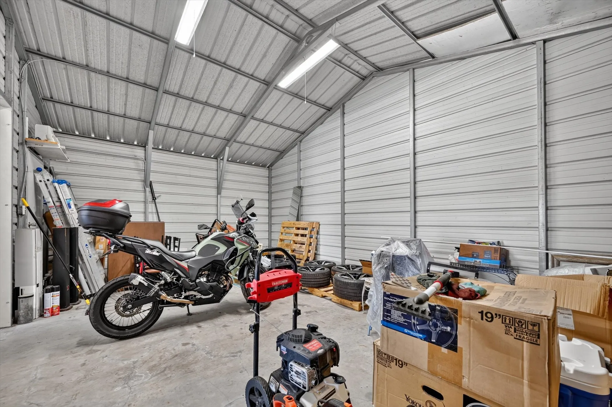 Spacious metal structure featuring corrugated metal walls and ceiling