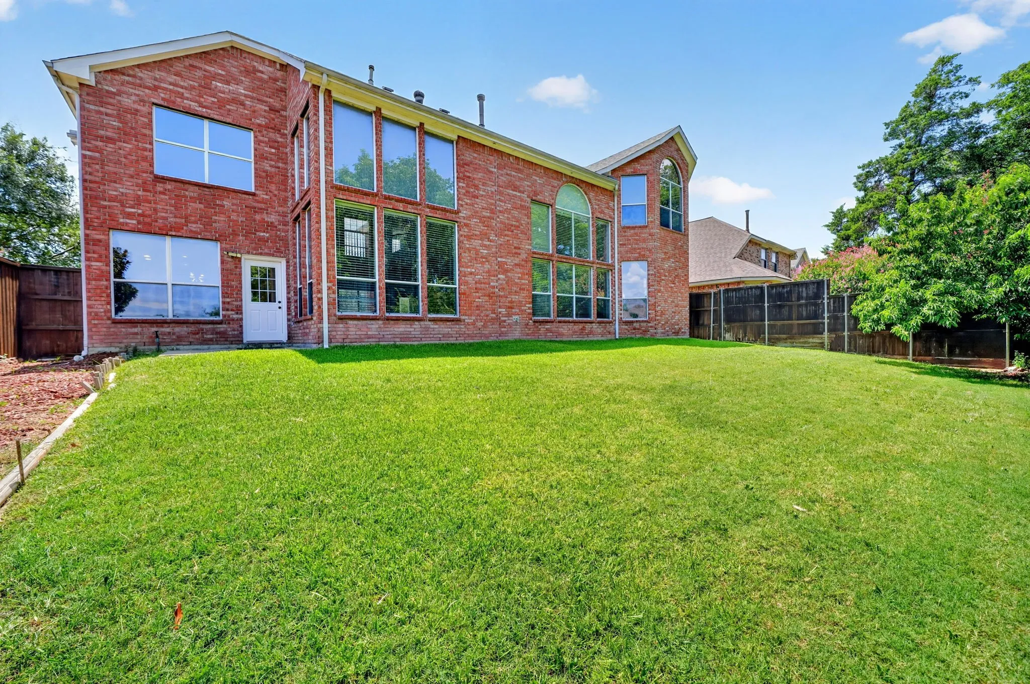 Rear elevation and large fenced backyard