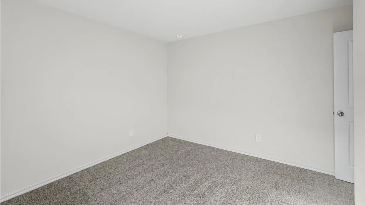 Neutral-toned room featuring light gray walls and a complementary gray carpet
