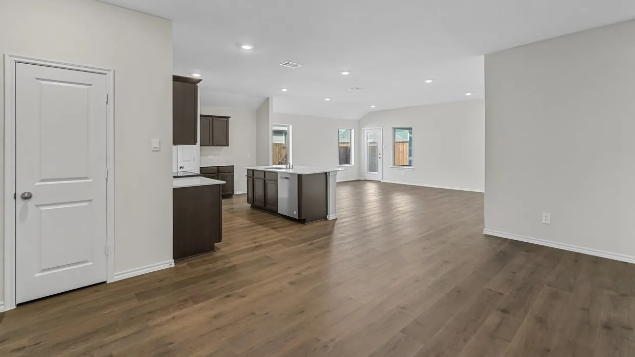 Open-concept layout featuring wide plank wood-finish flooring, recessed lighting, and a white interior paint palette