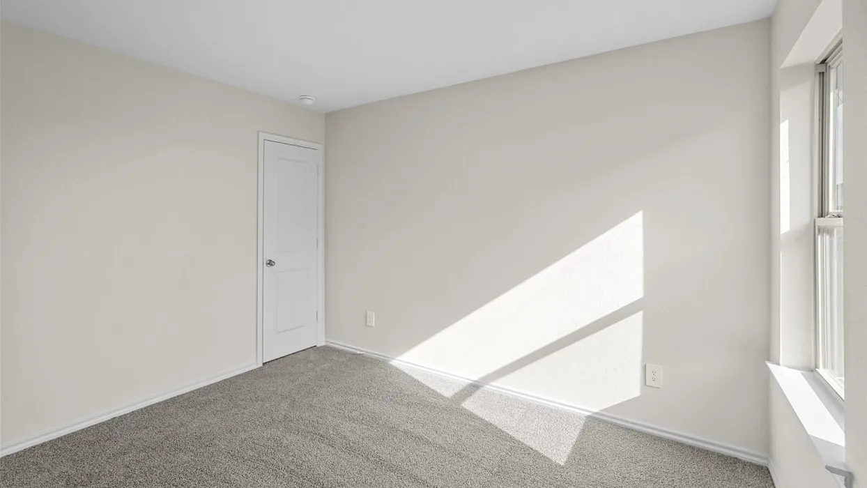 Room featuring light gray carpet, neutral wall paint, and a white single-pane window
