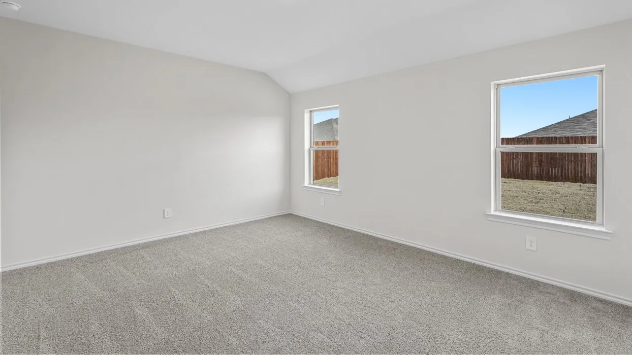 Spacious room featuring neutral carpeting and light-toned walls