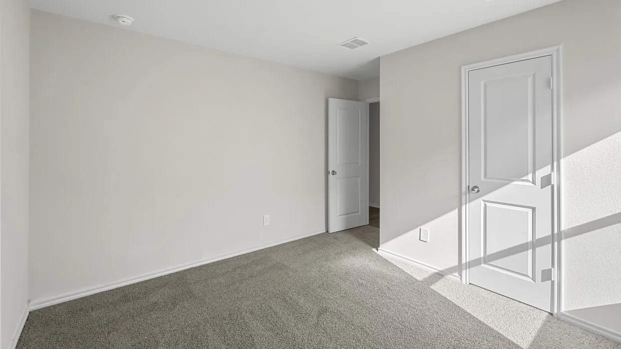 Neutral-toned walls and grey carpet flooring define this interior space